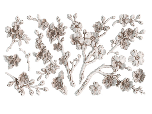White clay castings from Iron Orchid Designs Blossom Mould. The image shows white castings sprigs of cherry blossoms on a white background