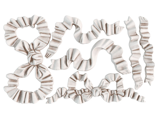 White castings on a white background of Iron Orchid Designs Bows mould
