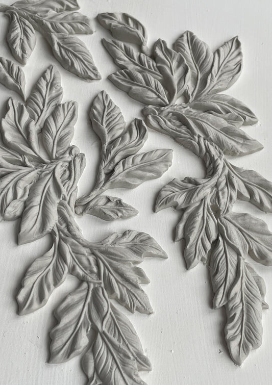 A close up image of white castings on a white background from Iron Orchid Designs Viridis mould