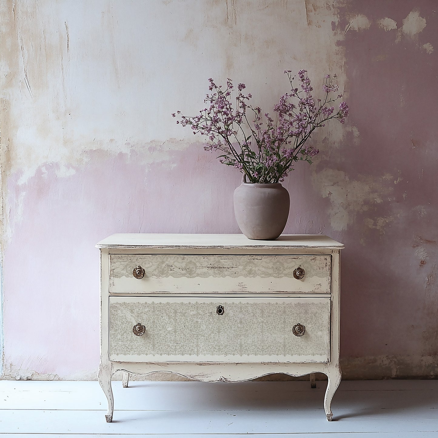 Vintage-style chest of drawers stamped with Iron Orchid Designs Lace Stamp with a vase of flowers against a textured wall.