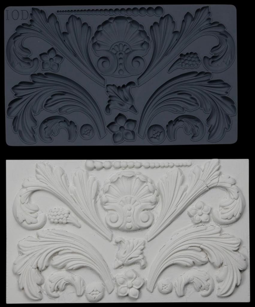 Iron Orchid Designs Acanthus Scroll Mould above white castings of the mould