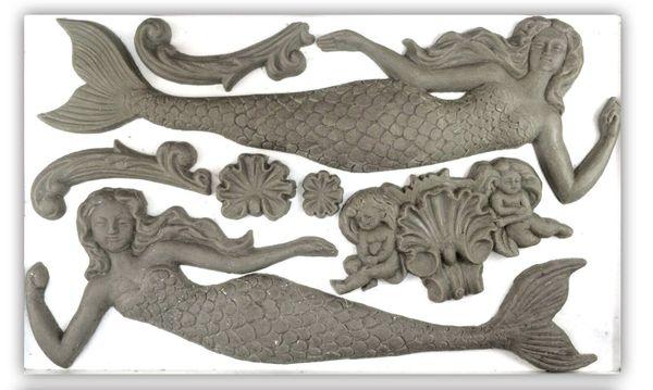 Clay castings made from Iron Orchid Designs Sea Sisters Mermaids grey silicone Mould on a white background