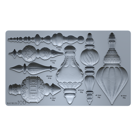 A gray silicone mold tray featuring multiple ornate architectural finial and decorative relief designs, with printed measurements and weights in French. The brand name 'BAUBLES IOD' is visible in the bottom-left corner. Baubles mould by Iron Orchid Designs.