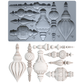 A silicone mold tray at the top shows multiple ornate architectural ornament cavity designs with small printed measurements. Below the tray are the corresponding molded ornament pieces in an off-white/ivory finish, arranged on a plain white background. Baubles mould by Iron Orchid Designs.