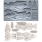 A mold tray and example castings for IOD Belsnickel Christmas ornaments, featuring a fish, gnome, Saint Nick, and holiday words like Joie, Noël, and Yule in a light gray and off-white color scheme.From Iron Orchid Designs.