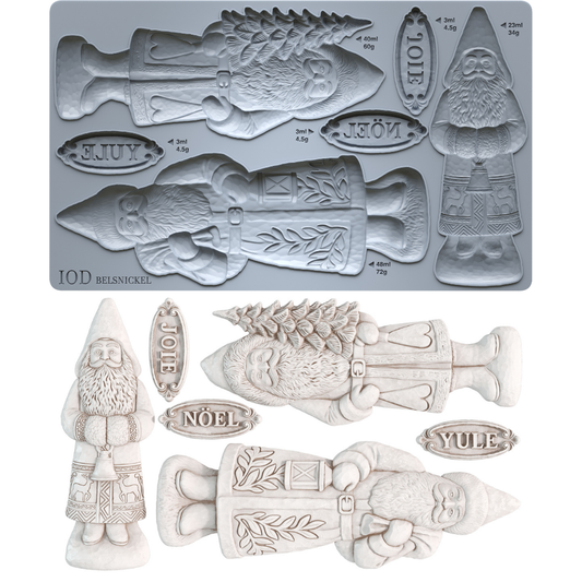 A mold tray and example castings for IOD Belsnickel Christmas ornaments, featuring a fish, gnome, Saint Nick, and holiday words like Joie, Noël, and Yule in a light gray and off-white color scheme.From Iron Orchid Designs.