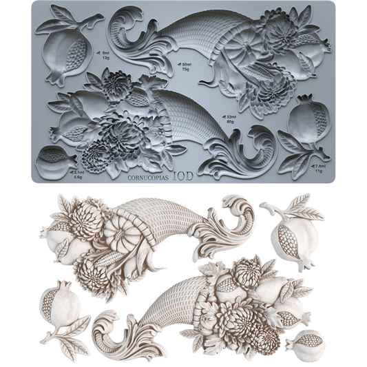 A I0D cornucopia mold shown in gray with its corresponding white 3D molded sample, featuring detailed floral, leaf, and pomegranate motifs on a white background. From Iron Orchid Designs.