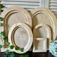 Set of wooden frames of different shapes and sizes on a dark surface with greenery by Iron Orchid Designs