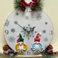Hand painted round gnome clock featuring snowflakes on the face and two gnomes at the bottom created from Bibelots mould.