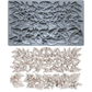 A gray silicone baking or craft mold sheet with embossed floral and leaf patterns, shown above a set of matching light beige carved floral and leaf pieces on a white background. Hazel and Bay. From Iron Orchid Designs.