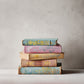 Stack of colourful books with decorative covers on a neutral background. The books have decorative spines created by Iron Orchid Designs Papillon transfer