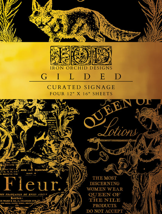 Packaging for Iron Orchid Designs Curated Signage Foil Transfer Pad featuring gold-colored designs on black background with text and illustrations.