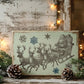 A rectangular vintage-style Christmas sign featuring Santa Claus in a sleigh with reindeer and snowflakes, styled on a rustic wooden surface with pine branches, pinecones, and warm string lights. From Iron Orchid Designs