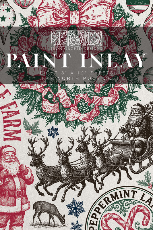 A Christmas-themed fabric pattern design sheet featuring vintage illustrations of Santa Claus, reindeer, snow globes, and ornaments in red, green, and black ink on an off-white background, with a dark gray text overlay reading 'PAINT INLAY'. From Iron Orchid Designs