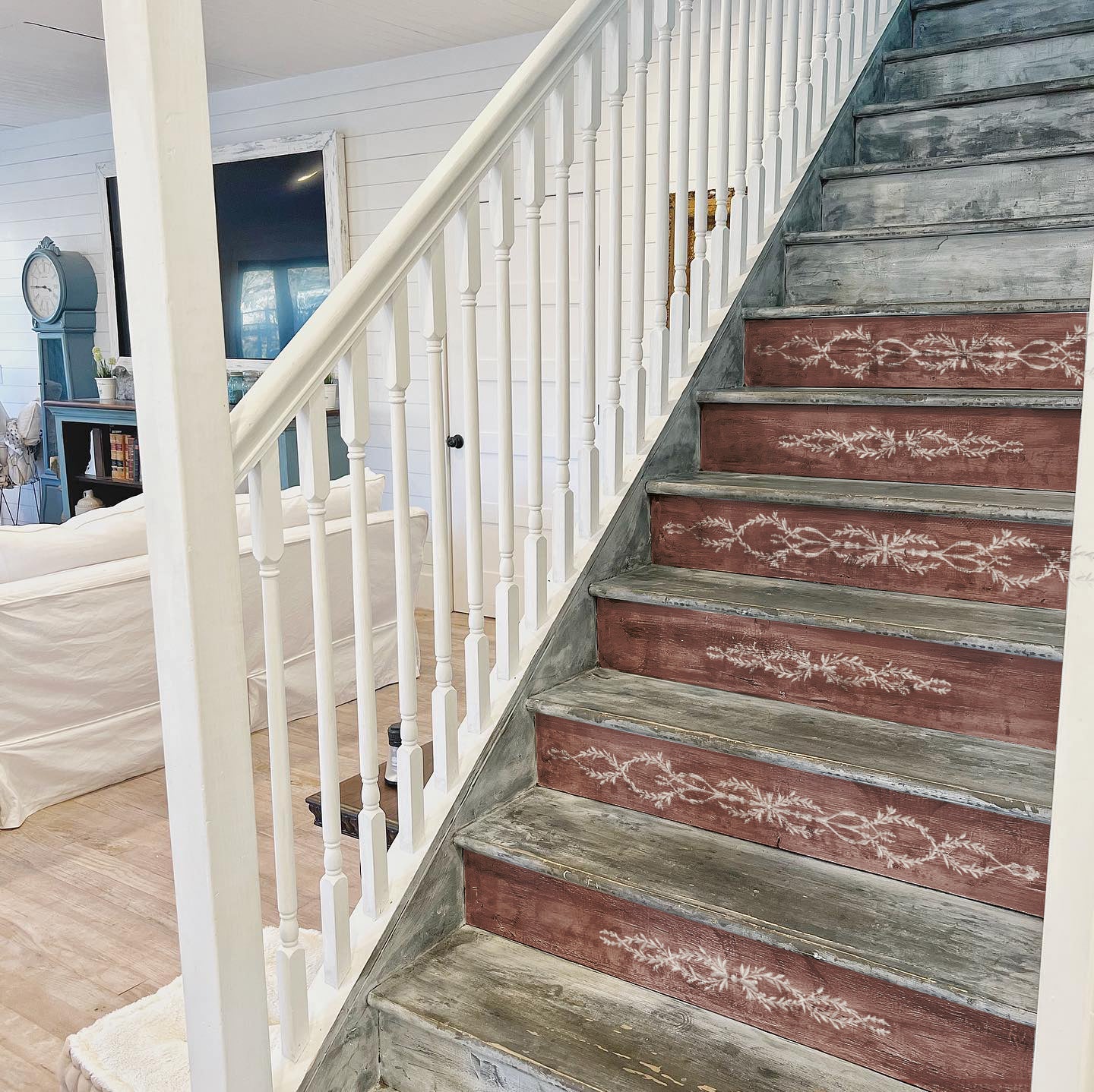 Iron Orchid Designs Tromp l'oeil Laurel Paint Inlay used on the risers of dark wood stairs with a light coloured staircase