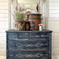 Iron Orchid Designs Tromp l'oeil Laurel Paint Inlay used on the front of a dark blue painted chest of drawers