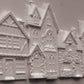 White embossed resin decorative pieces shaped like houses and cottages, shown on a plain light background. Charlbury Lane mould From Iron Orchid Designs.