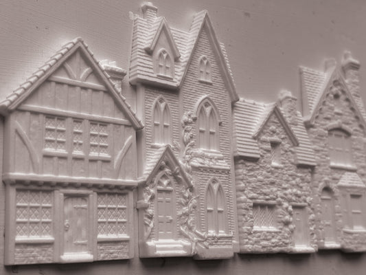 White embossed resin decorative pieces shaped like houses and cottages, shown on a plain light background. Charlbury Lane mould From Iron Orchid Designs.