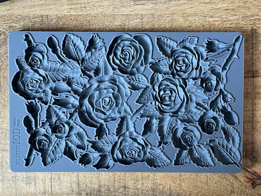 Iron Orchid Designs Juliette grey Mould laying on a wooden surface