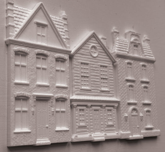 White clay miniature building pieces for dioramas, featuring detailed house designs with windows, doors, and textured brick patterns, arranged on a light gray background. Old Colchester Road Mould From Iron Orchid Designs.