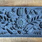 Iron Orchid Designs Primitive folk art grey Mould laying on a wooden surface