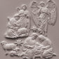 White clay castings depicting the Holy Family, angels, and sheep on a textured light gray background. Silent Night mould from Iron Orchid Designs.