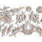White clay castings of cherubs, swirls and decorative elements from Iron Orchid Designs Cadre Mould
