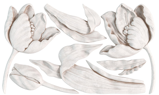 A close up of white castings from Iron Orchid Designs Tulips mould. White detailed florals and leaves on a white background