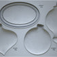 A grey silicone mould from Iron Orchid Designs Bibelots featuring shapes for crafting Christmas ornaments, with four different bauble shapes and an oval disc.