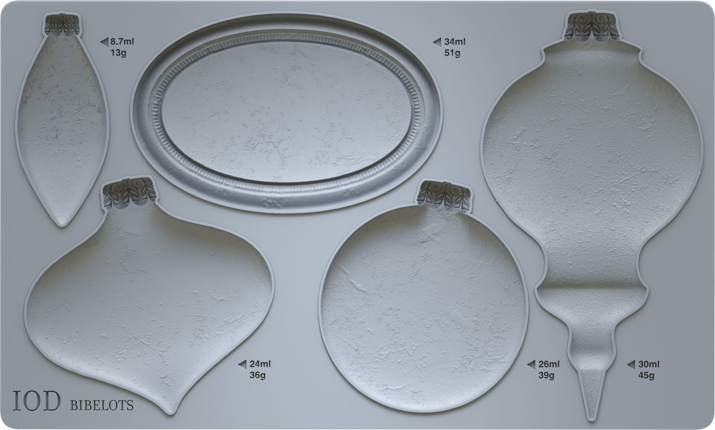 A grey silicone mould from Iron Orchid Designs Bibelots featuring shapes for crafting Christmas ornaments, with four different bauble shapes and an oval disc.