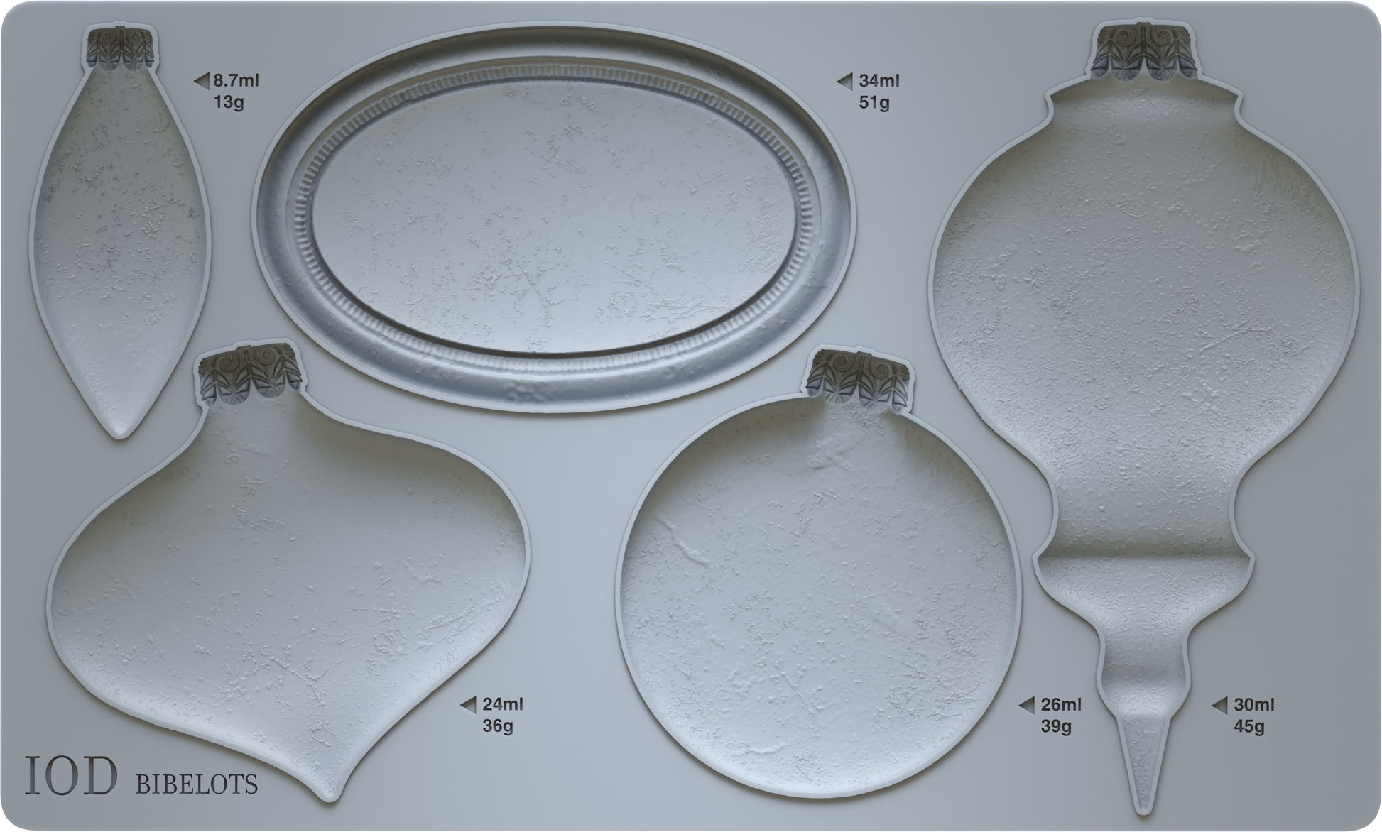A grey silicone mould from Iron Orchid Designs Bibelots featuring shapes for crafting Christmas ornaments, with four different bauble shapes and an oval disc.