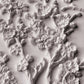 A close up image of white clay castings from Iron Orchid Designs Blossom mould on a white background