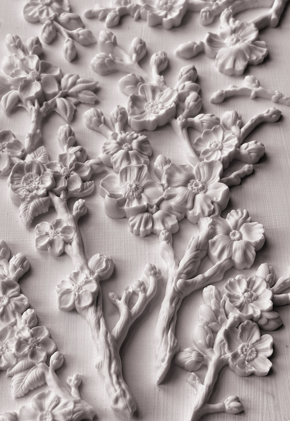 A close up image of white clay castings from Iron Orchid Designs Blossom mould on a white background