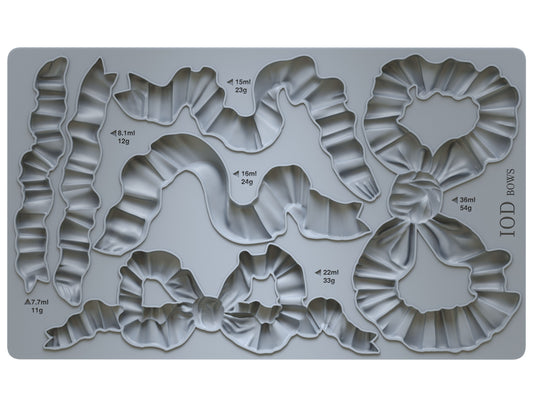 A grey silicone decor mould by Iron Orchid Designs featuring various bow shapes for crafting and baking