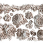 White clay castings on a white background from Iron Orchid Designs Felicite mould. High detailed roses and flowers alongside a long swag.