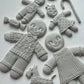 White castings of gingerbread people on a white background. From Iron Orchid Designs