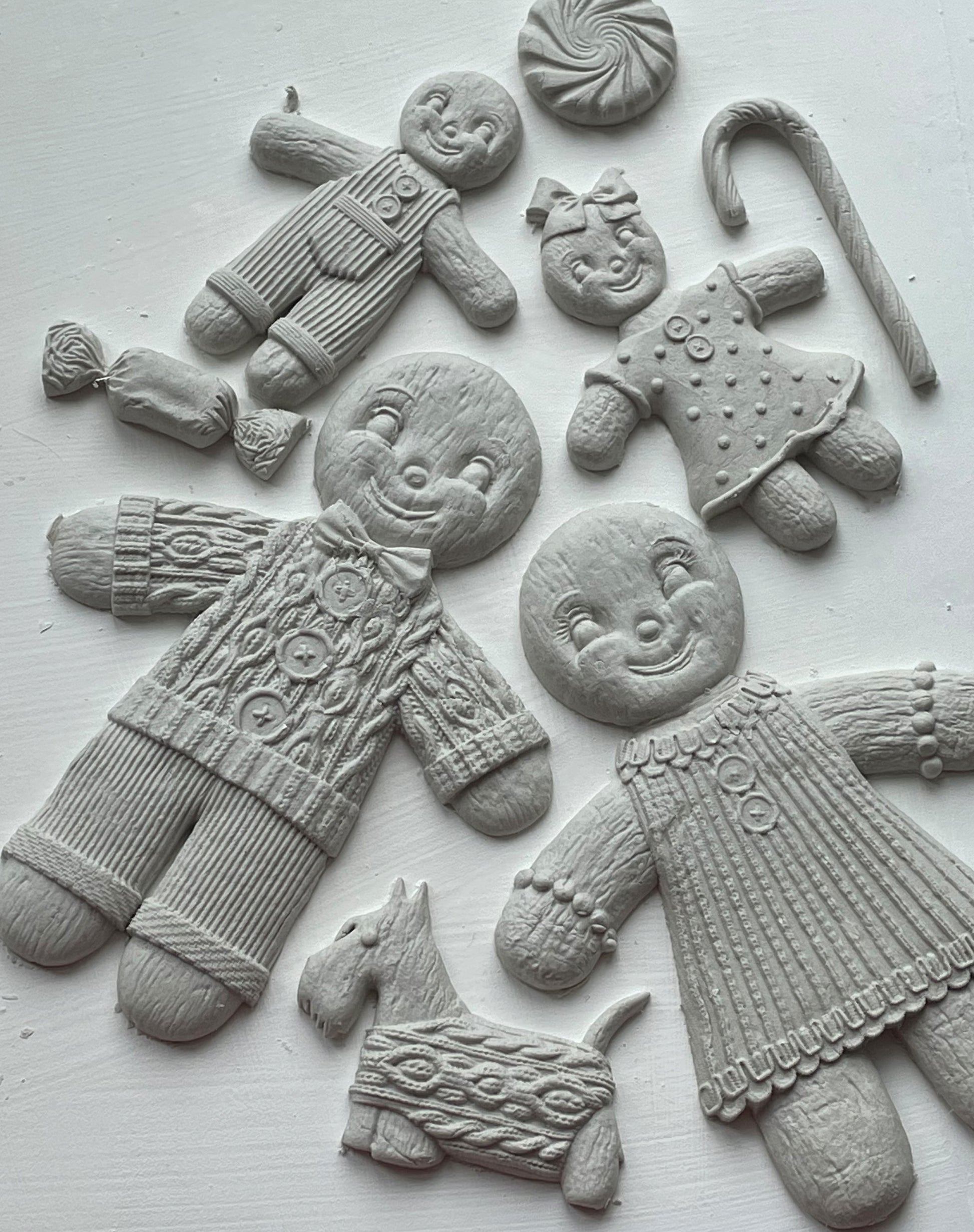 White castings of gingerbread people on a white background. From Iron Orchid Designs