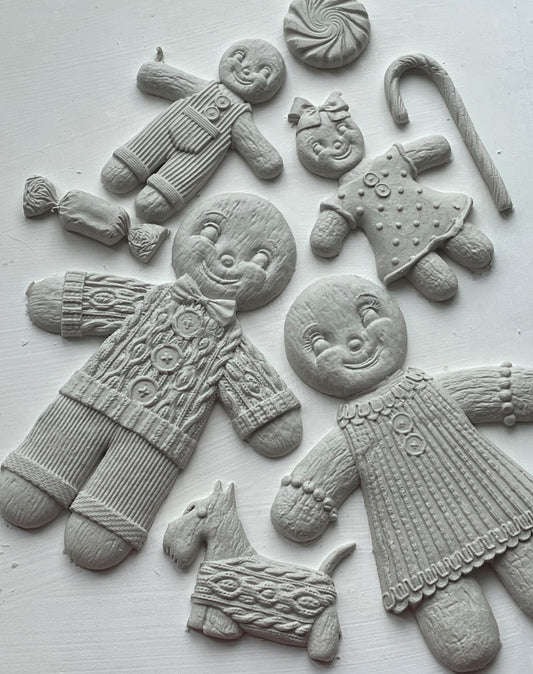 White castings of gingerbread people on a white background. From Iron Orchid Designs