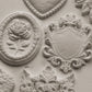 White clay castings from Iron Orchid Designs Heraldry mould on a white background