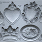 A grey silicone mould from Iron Orchid Designs featuring images from Heraldry. Wings, a crown, a shield and more