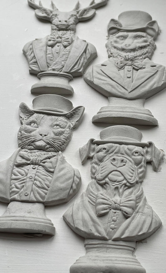 An image showing the four white bust castings from Iron Orchid Designs Invitation Only Mould. There is a cat, a dog, a fox and a stag on a white background