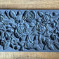 Iron Orchid Designs Juliette grey Mould laying on a wooden surface