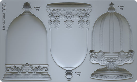 A set of three decorative bell-shaped moulds with intricate detailing, labeled as 'Les Cloches' from Iron Orchid Designs.