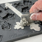 Person using a tool to press air dry clay into the Les Croix mould from Iron Orchid Designs 