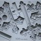 A grey silicone mould from Iron Orchid Designs featuring a collection of nine decorative crosses.