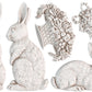 White clay castings of three rabbits , a basket and a decorative egg from Iron Orchid Designs Les Lapins mould. The castings are on a white background