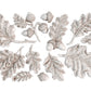 White castings from Iron Orchid Designs Oak Leaves an Acorns mould. The images shows a collection of acorns and leaves on a white background