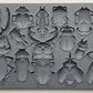 A grey silicone mould from Iron Orchid Designs featuring various insect shapes, such as beetles and bugs for crafting and baking purposes.