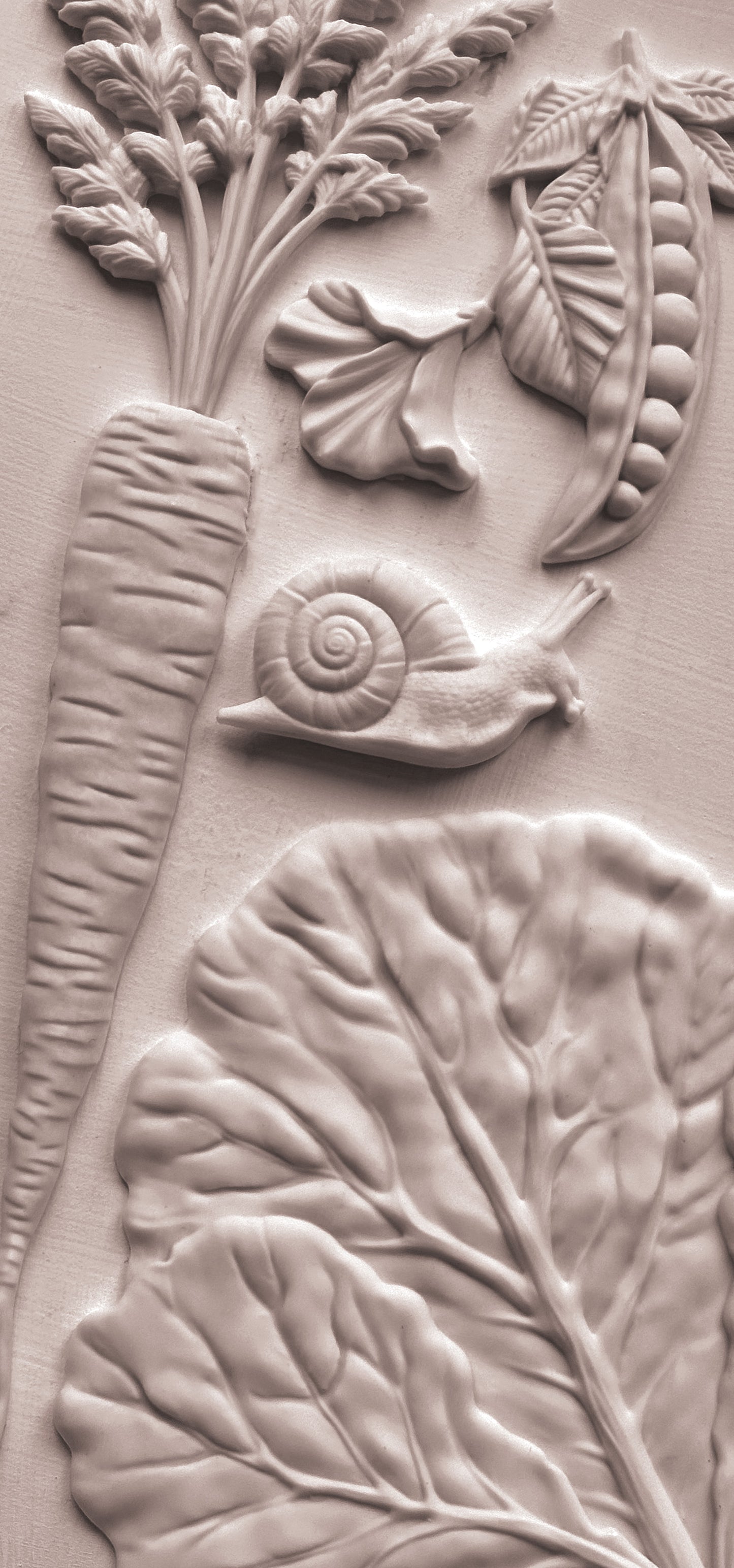 Close up of white castings from Iron Orchid Designs Spring Garden Mould on a white background