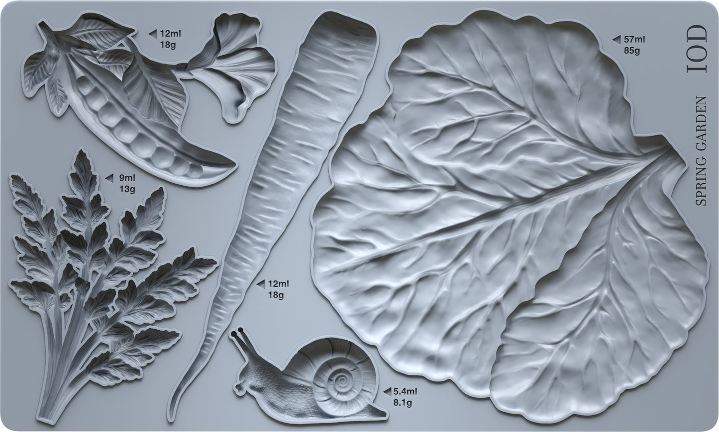 Grey silicone Spring Garden mould from Iron Orchid Designs showing a cabbage leaf, a carrot, carrot tops, a pea pod and a snail